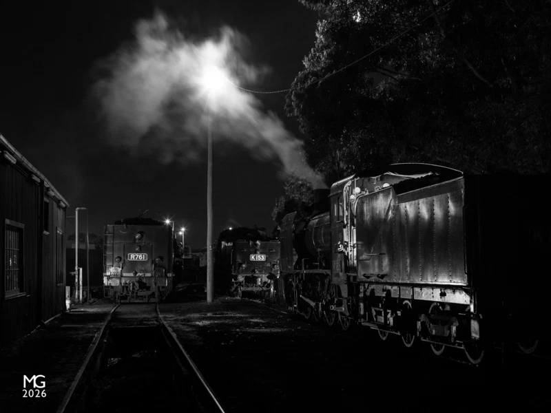 Night at Newport K163, K153, and R761 simmer away outside the weighbridge at Newport Workshops during the 2020 Open Days weekend. This is a composite of three photographs with different lighting effects used in each shot. In addition to the sodium yard light, additional lighting is courtesy of three off-camera flashes and a Milwauke 18V battery torch