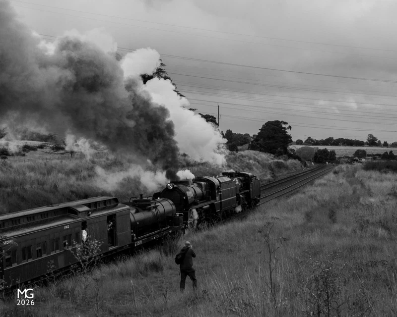The Shot A lone photographer captures Steamrail's R711 and A2 986 powering up Warrenheip Bank. Ahead of the train, the two tracks split - on the left is the main line to Melbourne via Bacchus Marsh, and the right continues onwards to Geelong. Once a busy junction station with platforms, buildings, a signal box, and sidings, nowadays little remains to indicate this was once an important waypoint on the way to Victoria's goldfields.