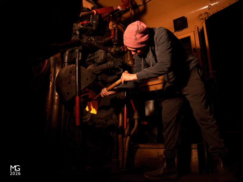 Overnight sizzle Before resting up for the night, one of Steamrail's volunteers tops up the fire of K183 during the 2022 Newport Workshops Open Days event.