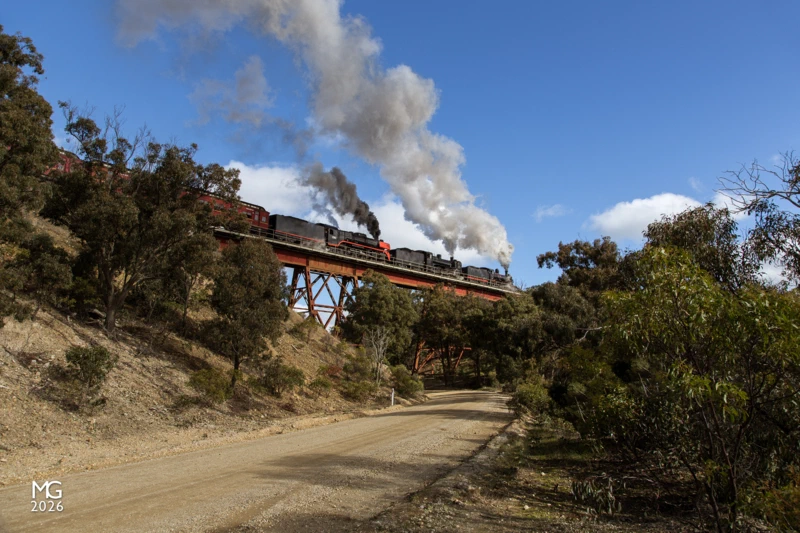 Late running 80 minutes after it should have arrived in Ballarat (some 45 kilometers away), Steamrail's D3 639, A2 986, and R761 storm across the Ironbark Gorge bridge between Bacchus Marsh and Ballan with Steamrail Victoria's "Steam Spectacular" tour through Western Victoria. A late departure from Southern Cross Station, pathing troubles, and a suffocated fire in the D3, all compounded to make this trip severely late. Despite - or perhaps, in spite of - all the delays and problems the heritage volunteers, V/Line, and RTBU, all worked together to keep the tour running as best to plan, and deliver the promised parallel run later that evening between Geelong and Lara.