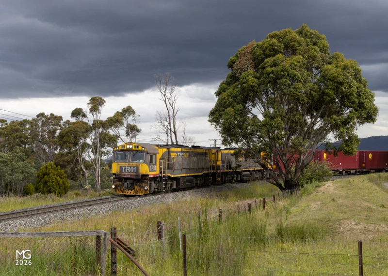 Stormclouds TR11 and TR13, adorned with their Christmas Train LED panels, sweep towards the Rhyndaston Road level crossing between Colebrook and Rhyndaston with a train from the paper mill at Boyer, on Hobart's outskirts. Not long after this photo was taken the stormclouds opened up, putting an end to the chase.
